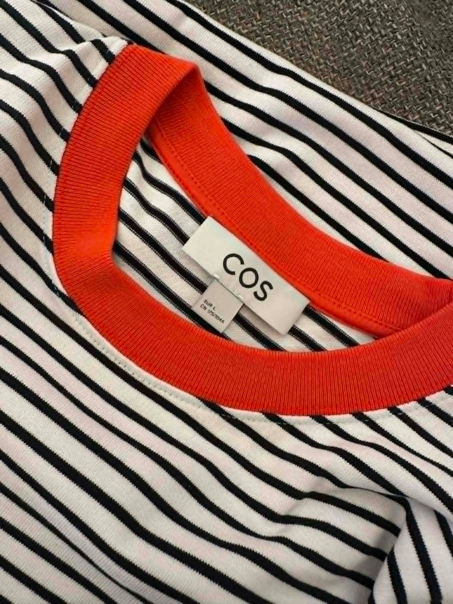 COS brand label close-up showing size EU L
