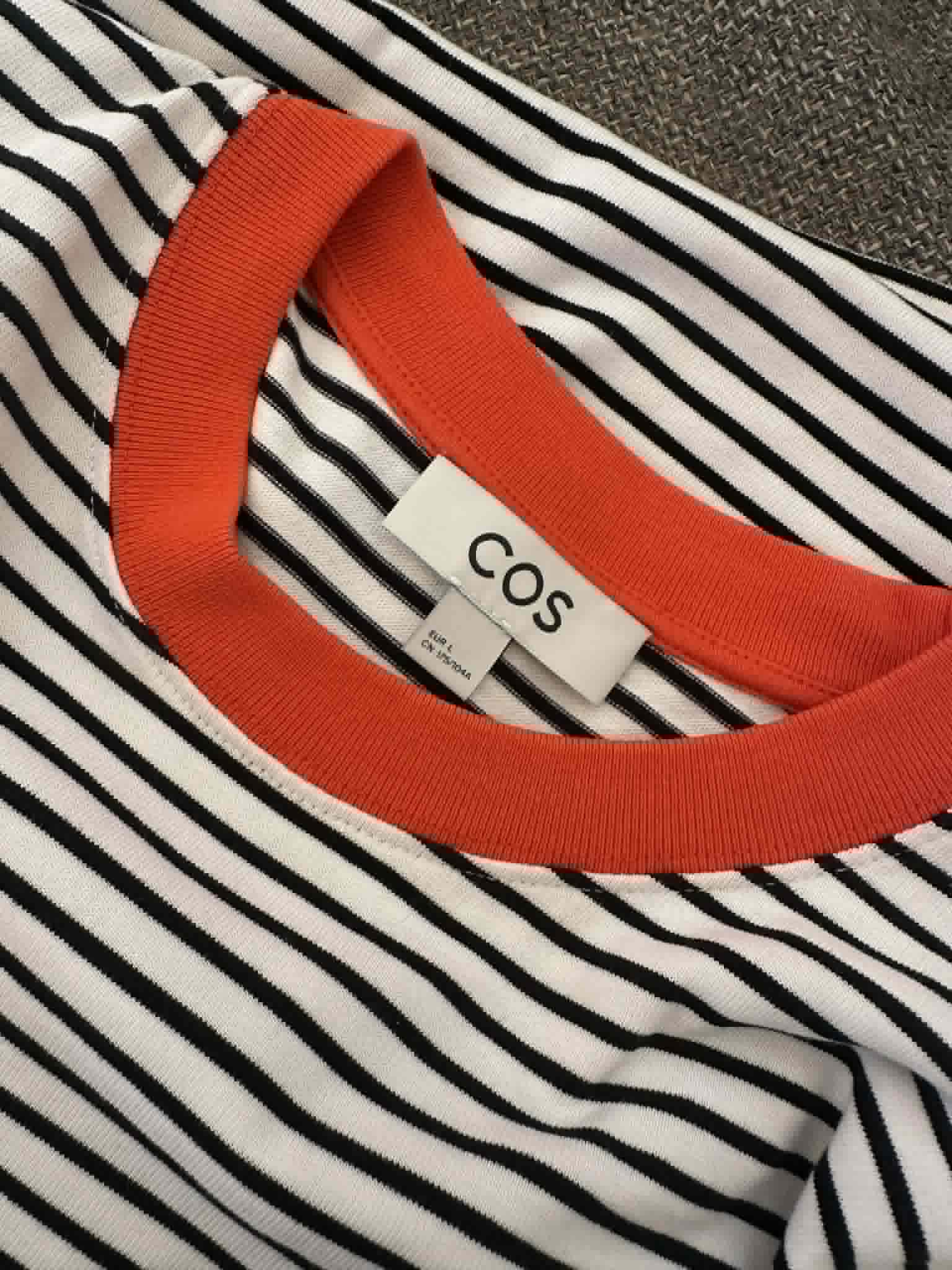 COS brand label close-up showing size EU L