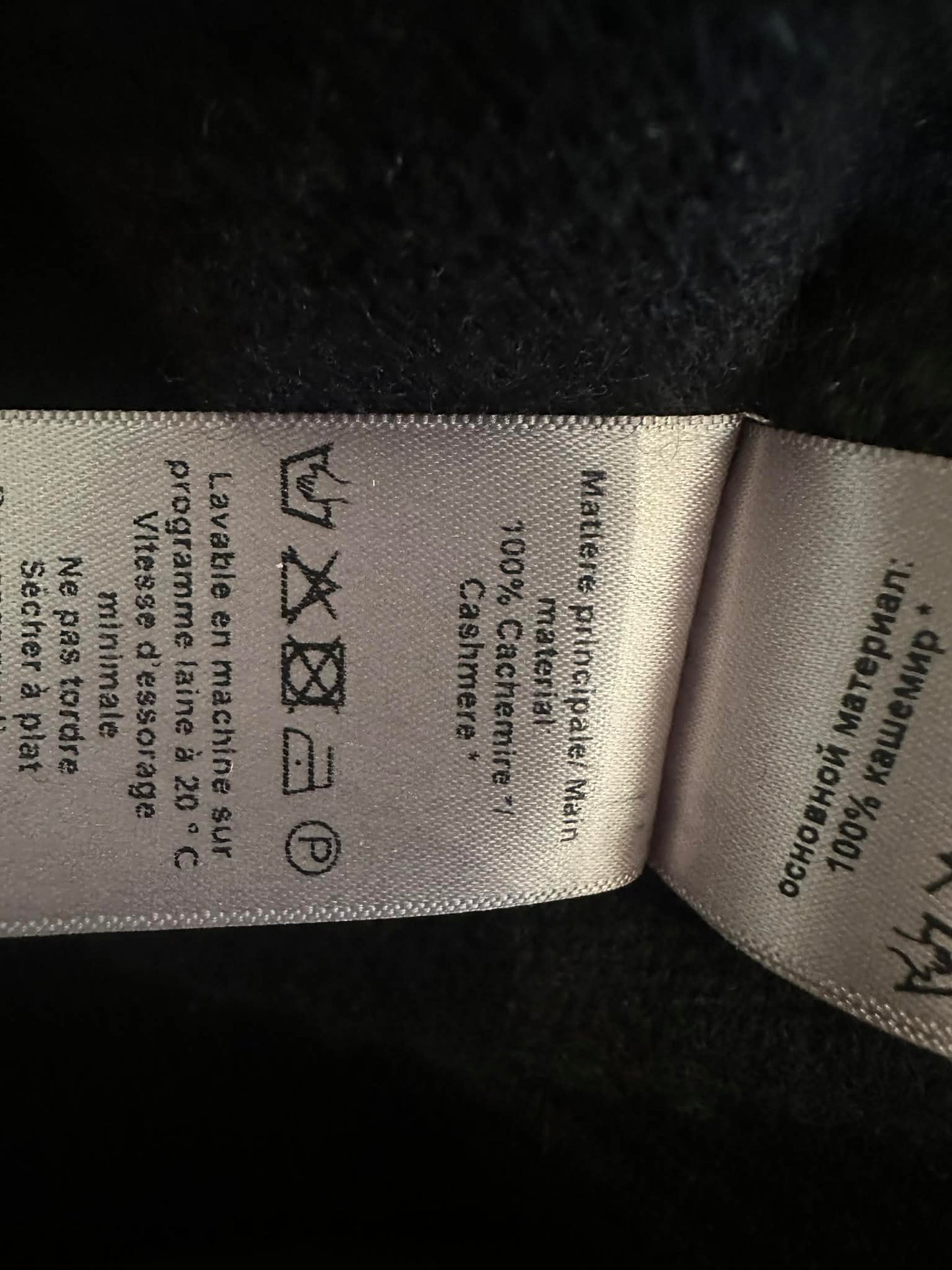 Care label showing 100% cashmere and wash instructions
