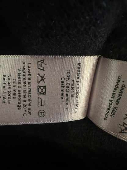 Care label showing 100% cashmere and wash instructions